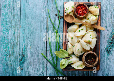 Dumplings is a Slavic dish, common in Ukrainian cuisine, in the form of boiled unleavened dough stuffed with vegetables Stock Photo