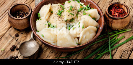 Dumplings is a Slavic dish, common in Ukrainian cuisine, in the form of boiled unleavened dough stuffed with vegetables Stock Photo