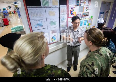 KUCHING, Malaysia (April 11, 2019) – Dr. Chor Yek Kee explains statistics related to the pediatric intensive care unit to Malaysian Army Sgt. Norhasila Jaber, Canadian Army Capt. Kaethe Sabr, U.S. Navy Lt. Sharon Hoff and Lt. Cmdr. Phonthip Eadens during a subject matter expert exchange at Sarawak General Hospital as part of Pacific Partnership 2019. Pacific Partnership, now in its 14th iteration, is the largest annual multinational humanitarian assistance and disaster relief preparedness mission conducted in the Indo-Pacific. Each year the mission team works collectively with host and partner Stock Photo