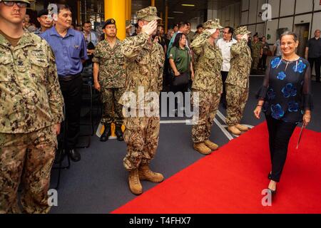 KUCHING, Malaysia (April 11, 2019) – Sideboys salute United States Ambassador to Malaysia, Kamala Lakhdhir at the Pacific Partnership 2019 closing ceremony in Malaysia. Pacific Partnership, now in its 14th iteration, is the largest annual multinational humanitarian assistance and disaster relief preparedness mission conducted in the Indo-Pacific. Each year the mission team works collectively with host and partner nations to enhance regional interoperability and disaster response capabilities, increase security and stability in the region, and foster new and enduring friendships in the Indo-Pac Stock Photo