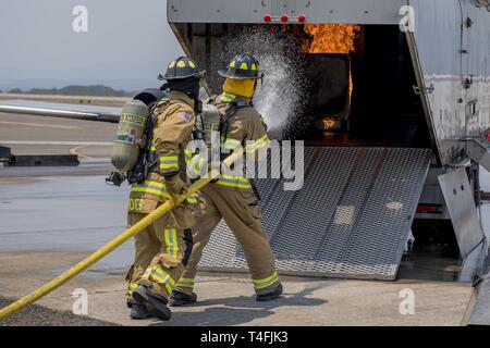 Firefighters from the 612th Air Base Squadron demonstrate their capabilities to extinguish fires during the 12th Air Force commander visit April 7, 2019, at Soto Cano Air Base, Honduras. U.S. Air Force Maj. Gen. Andrew Croft, 12th AF commander, and Command Chief Master Sgt. John Storms, 12th AF command chief, visited members assigned to Joint Task Force – Bravo and 612th Air Base Squadron to host a town hall and meet with unit leadership. Stock Photo