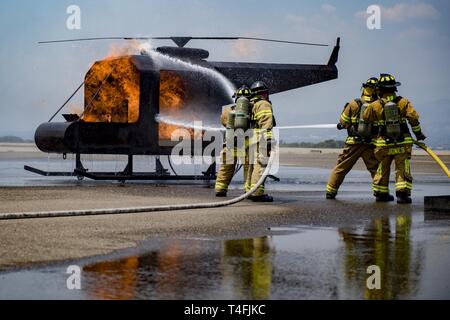 Firefighters from the 612th Air Base Squadron demonstrate their capabilities to extinguish fires during the 12th Air Force commander visit April 7, 2019, at Soto Cano Air Base, Honduras. U.S. Air Force Maj. Gen. Andrew Croft, 12th AF commander, and Command Chief Master Sgt. John Storms, 12th AF command chief, visited members assigned to Joint Task Force – Bravo and 612th Air Base Squadron to host a town hall and meet with unit leadership. Stock Photo