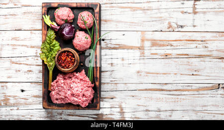 Fresh raw minced beef on cutting board and ingredients Stock Photo