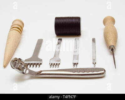 Leather working tools isolated on white background. Stock Photo