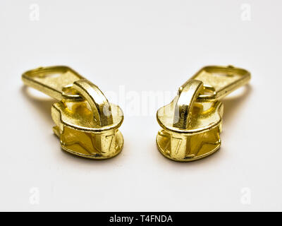 Two gold color zipper heads isolated on white background. Stock Photo