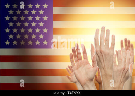 People raising hands and American flag on background. Patriotic concept Stock Photo