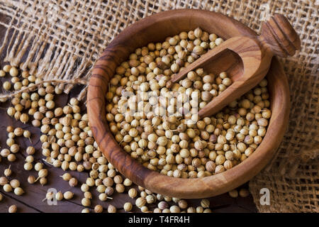 Coriander seeds in a wooden bowl Stock Photo