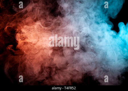Background of orange, purple, red and blue wavy smoke on a black isolated ground. Abstract pattern of steam from vape of smoothly rising clubs. Mocap  Stock Photo