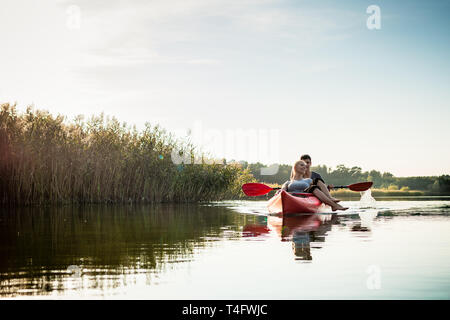Woman relaxing in kayak with her boyfriend Stock Photo
