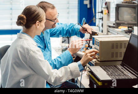 Team of electronic engineers testing a product prototype Stock Photo