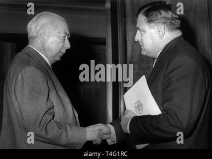 German president Theodor Heuss (r) presents the letter of appointment to Franz Josef Strauß, Germanys new secretary of defense on 18 October 1956. He succeeds Theodor Blank. | usage worldwide Stock Photo