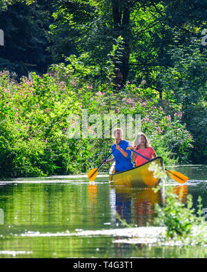 Mother and daughter steering canoe on franconian river Stock Photo
