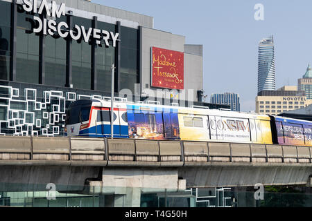 BTS Skytrain or The Bangkok Mass Transit System running pass Siam Discovery and Art Gallery in Bangkok during peak time on 02 /11 /2018 , Thailand Stock Photo