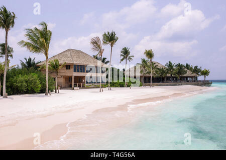 Coast from the sea to maldives bungalows. Luxury holiday resort.Tropical blue Maldives sea. Beautiful amazing nature landscape. Stock Photo