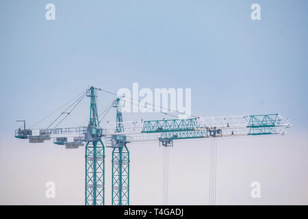 Construction of the new building. Two cranes in winter Stock Photo
