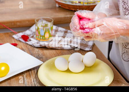 woman paint a egg made of polystyrene. Colorized acrylic egg Stock Photo
