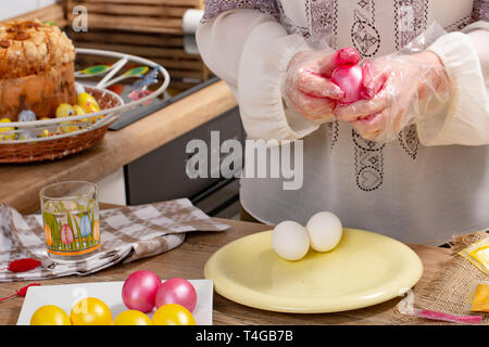 woman paint a egg made of polystyrene. Colorized acrylic egg Stock Photo