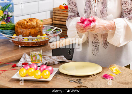 woman paint a egg made of polystyrene. Colorized acrylic egg Stock Photo