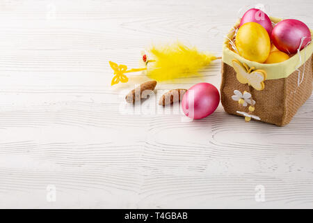 Easter eggs in box on white wooden background, turquoise Easter background Stock Photo