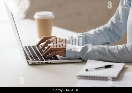 Closeup photo of woman hands typing on notebook at desktop Stock Photo