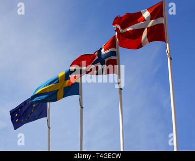Flags from the Scandinavian countries Denmark, Norway and Sweden waving from flagpoles together with the EU, European Union, flag against a blue sky. Stock Photo