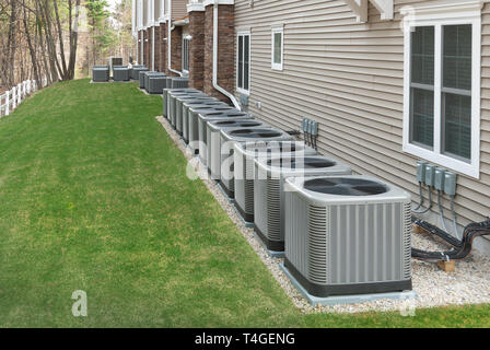 Modern air conditioning and heating units or heat pumps, used in homes and apartments without central air conditioning Stock Photo