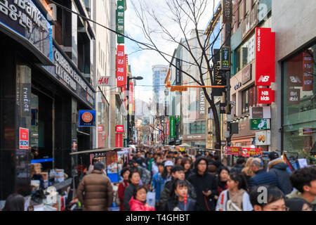 Seoul, South Korea - Mar 30, 2019: People walking down bustling Myeongdong street, one of the most popular tourists destination in Seoul. Stock Photo