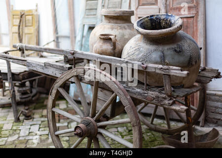 two old ceramic dishes for water and oil made from dark clay Stock Photo