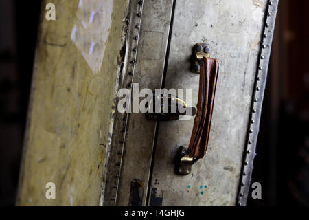 Close up of isolated old used suitcase with rivets, leather grip and combination locks Stock Photo