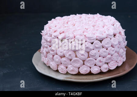 Festive cake covered with pink cream on a dark background, Copy space Stock Photo