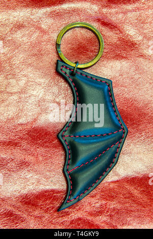 Leather key ring in the shape of bat wing. Vampire symbols. Stock Photo
