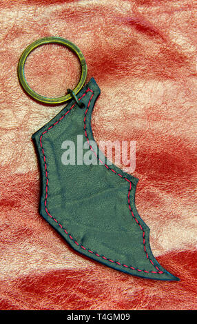 Leather key ring in the shape of bat wing. Vampire symbols. Stock Photo