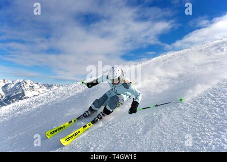 Young female skier with sporty style of skiing at the descent from the Hohe Salve, Hopfgarten, Tyrol, Austria Stock Photo