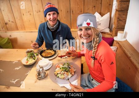 Skiers having lunch in a hut, Hohe Salve, Hopfgarten, Tyrol, Austria Stock Photo