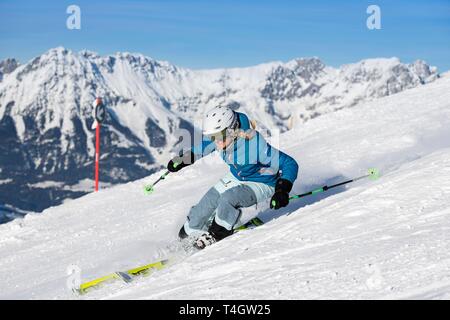 Young female skier with sporty style of skiing at the descent from the Hohe Salve, Hopfgarten, Tyrol, Austria Stock Photo
