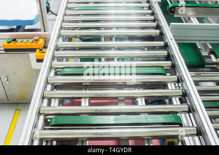 The conveyor chain, and conveyor belt on production line set up in clean room area. Stock Photo