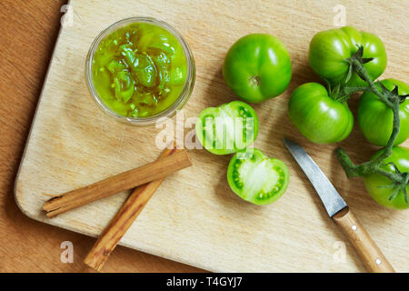 Jam or chutney in a glass jar made of green tomatoes with cinnamon, top view Stock Photo