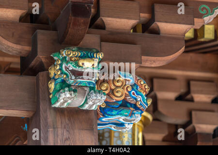 Shishi (Lion Guardian) at Honden (Main Hall) of Yushima Tenmangu or Yushima Tenjin. Shinto Shrine devoted to Tenjin, the Kami of Learning. Located in  Stock Photo