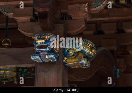 Shishi (Lion Guardian) at Honden (Main Hall) of Yushima Tenmangu or Yushima Tenjin. Shinto Shrine devoted to Tenjin, the Kami of Learning. Located in  Stock Photo