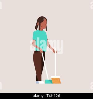 housewife sweeping floor with broom and scoop african american girl doing housework house cleaning concept female cartoon character full length flat Stock Vector