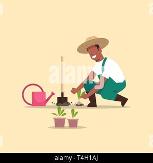 male farmer planting young seedlings plants flowers and vegetables african american man working in garden agricultural worker in uniform eco farming Stock Vector