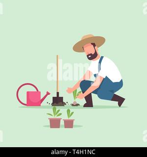 male farmer planting young seedlings plants flowers and vegetables man working in garden agricultural worker in uniform eco farming concept flat full Stock Vector
