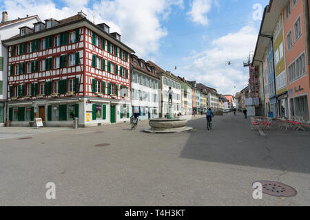 Winterthur, ZH / Switzerland - April 8, 2019: the hustle and bustle in the old town of Winterthur with people riding their bicycles in the foreground Stock Photo