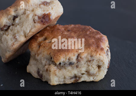 Two Delicious Fruit Scones on a Slate Serving Board. A good image for a bakery shop, Stock Photo