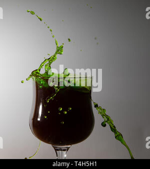 Green water splashing in a glass Stock Photo