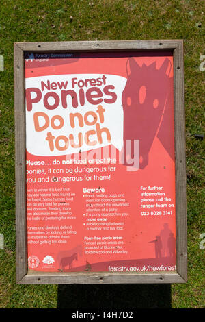Notice advising visitors not to touch the New Forest ponies Lyndhurst, New Forest, Hampshire, UK. Stock Photo