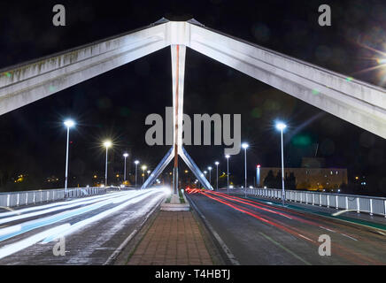 The 'Puente de la Barqueta' bridge in Seville illuminated at night Stock Photo