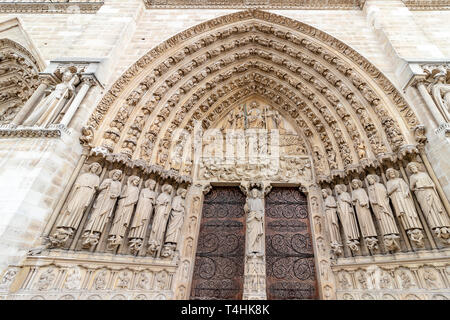 Main Entrance door of  Notre Dame Cathedral in Paris. Ornate Facade with sculptures statues and gargoyles. France Stock Photo