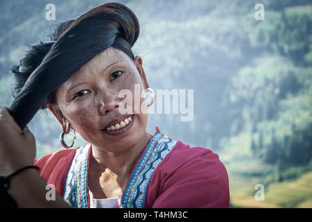 Close up portrait of Red Yao woman of Huangluo tribe, which are known for the “world’s longest hair village”. Longsheng Village Guilin, Guangxi, China Stock Photo