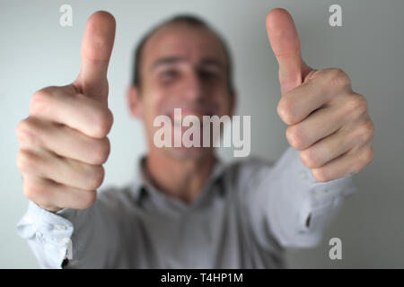 A smiling man facing the camera, expressing approval. Stock Photo